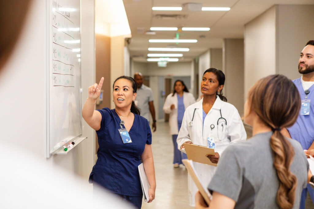 Group of medical professionals collaborating in hallway