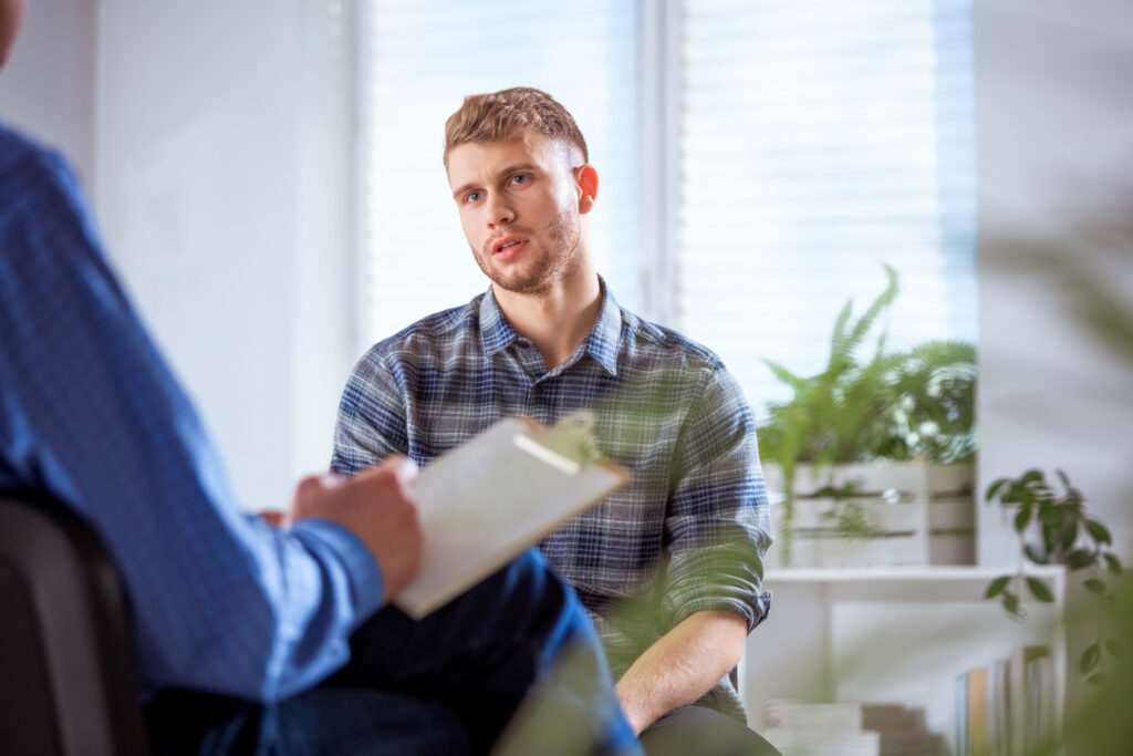 person on couch in counseling session with therapist