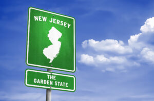 Road sign that says New Jersey the Garden State with outline of state