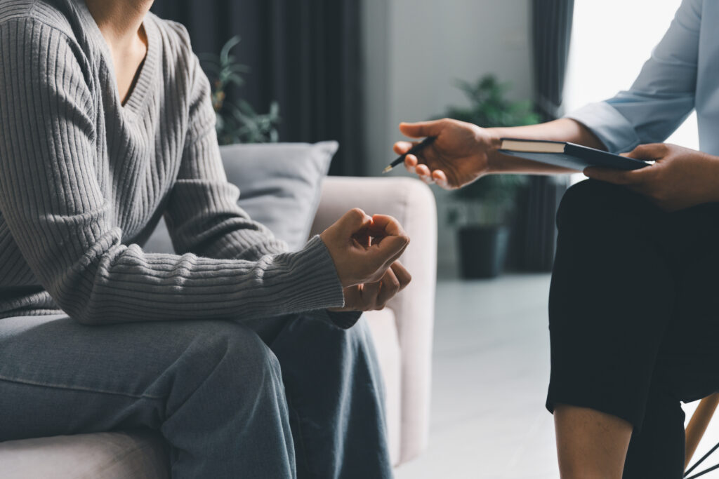 Anxious patient in therapy session talking to therapist