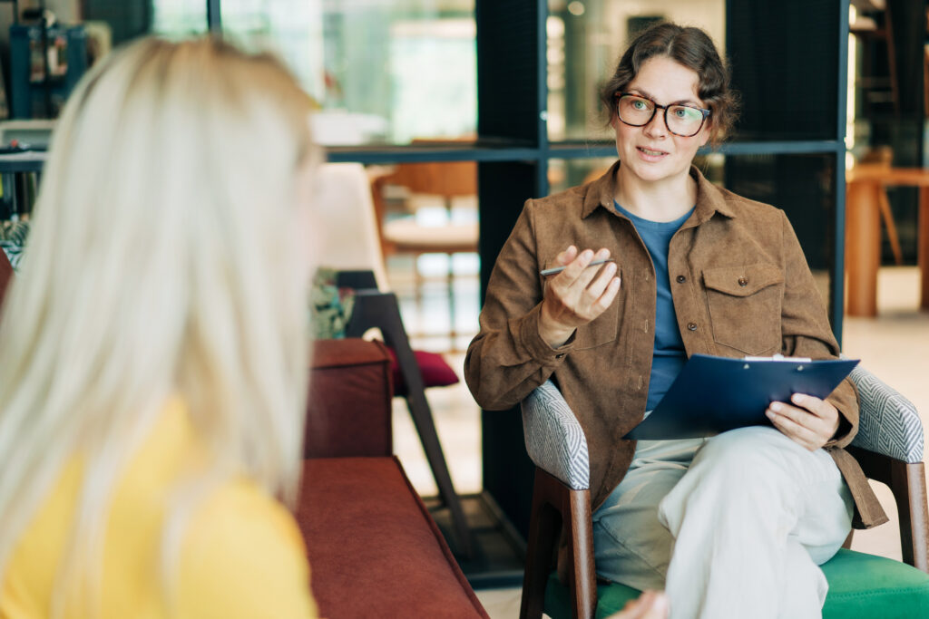 Psychologist talking with client in office