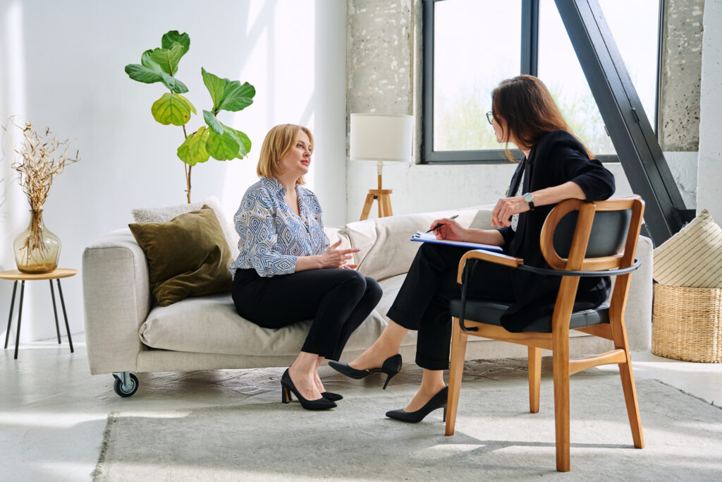 Therapist talking to patient in office setting