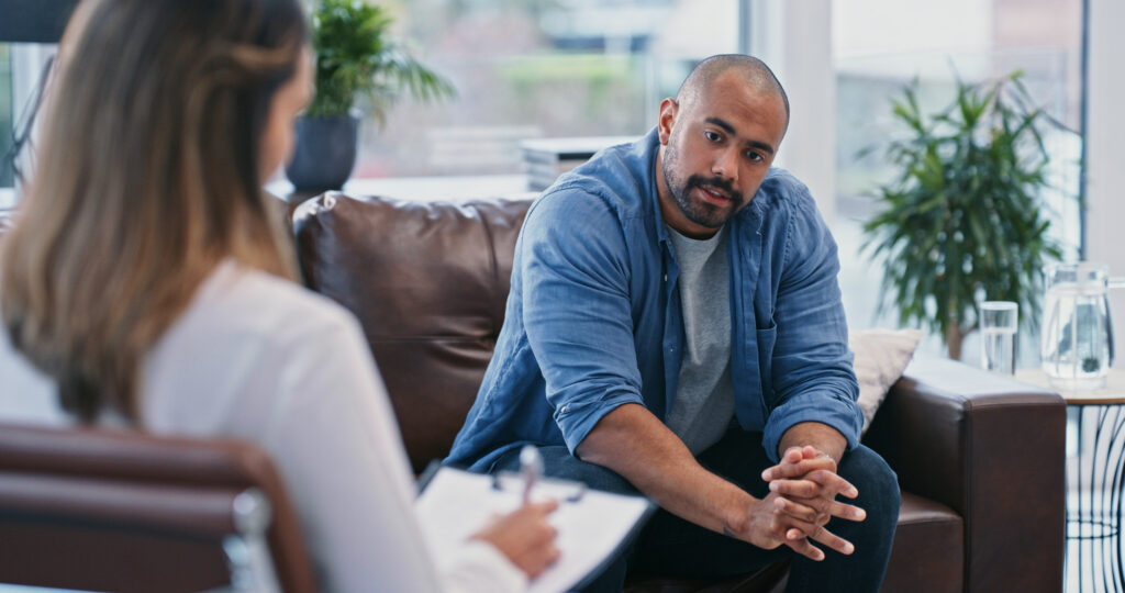 Person looking thoughtful while sitting in session with therapist