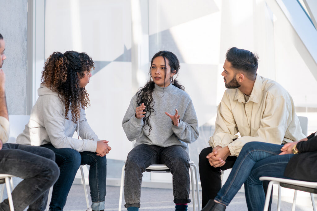 Group therapy session with one person talking to other members