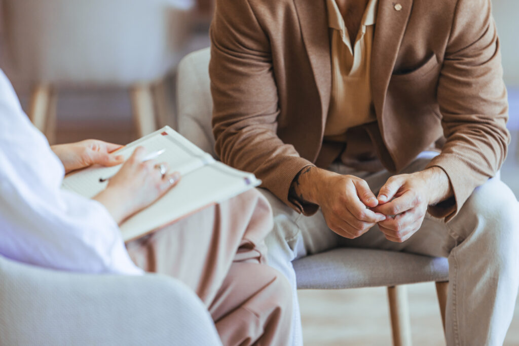 Therapist conducting counseling session with client in office setting